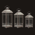 Three metallic lanterns of different sizes on a white background
