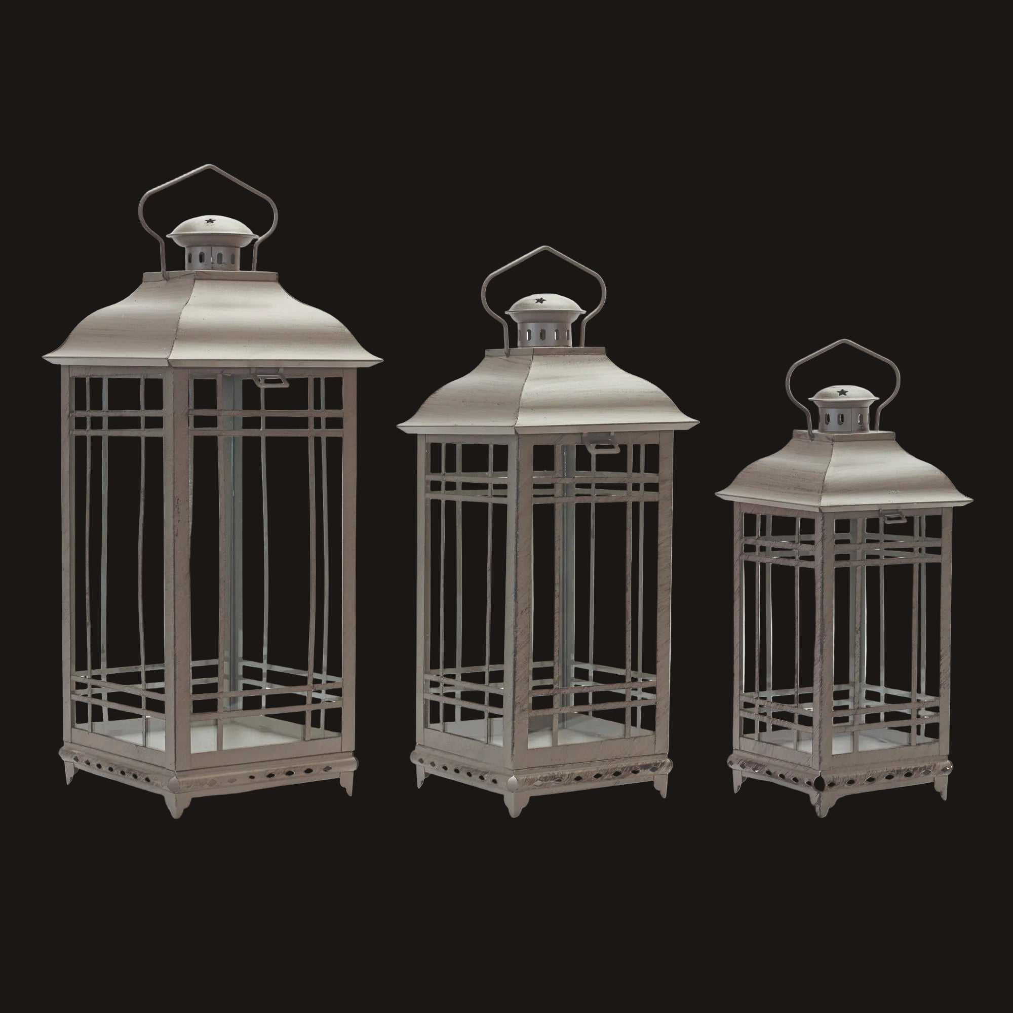 Three metallic lanterns of different sizes on a white background