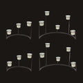 Set of four metal candelabra with candle holders on a white background