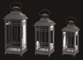 Three black metal lanterns of different sizes on a white background