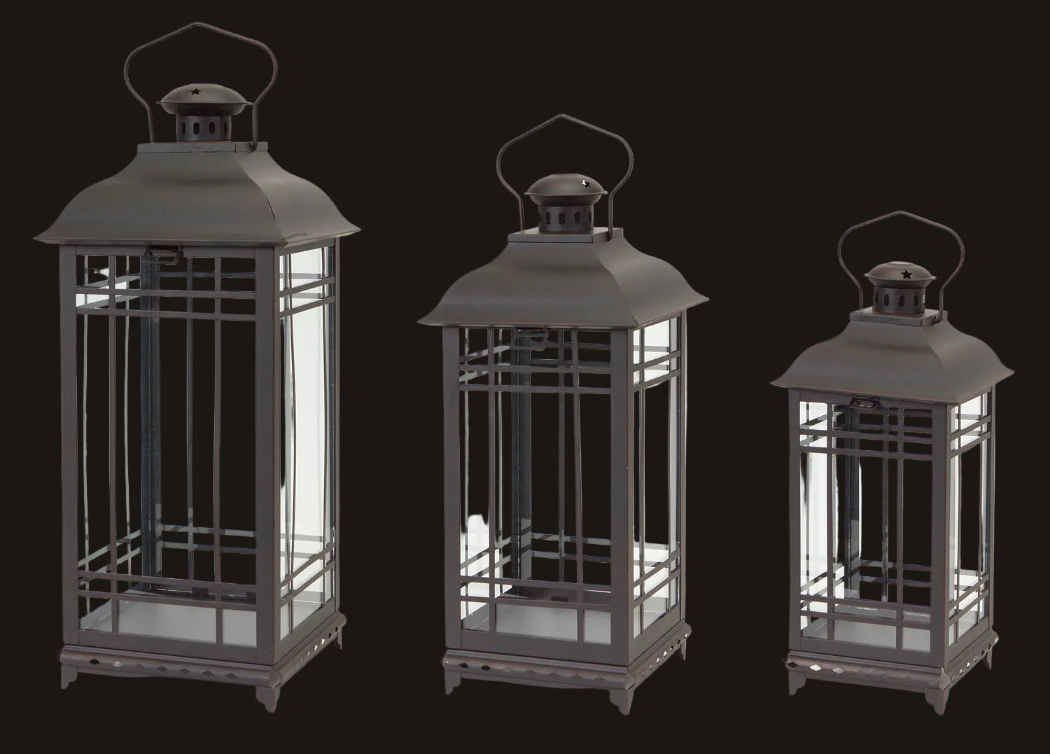Three black metal lanterns of different sizes on a white background