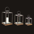 Three metal lanterns of different sizes on a white background