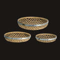 Three woven baskets with metal rims on a white background
