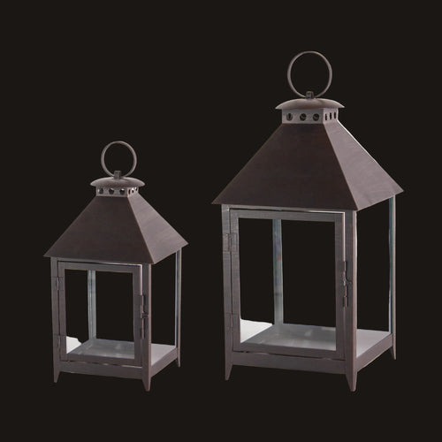 Two black lanterns with clear glass on a white background